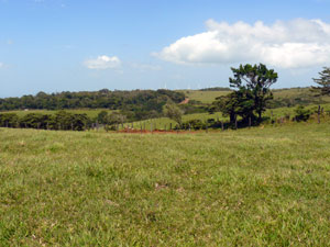 To the northwest, farms lead to a row of wind turnbines with propellers just visible behind a hill.