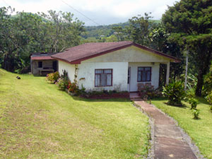 The property has a small 3BR 1BA house beside the road.