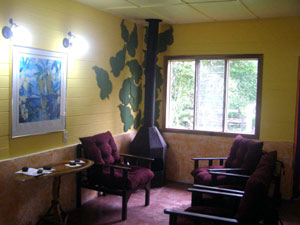 The living room in the main house is a pleasant, bright area with a free-standing fireploace. 