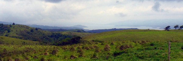 The gently rolling acreage with scattered forest has views down the whole length of Lake Arenal to Arenal Volcano.