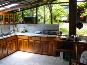 The roomy kitchen has fine wood cabinets and a unique stove.