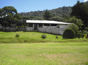 This large building contains a parking area, shop, and 2-story apartment.