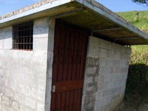 The finca includes this cement-roofed "Ft. Knox" storage building.