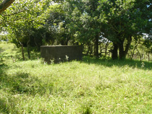 A large water tank is kept filled from a well by a pump. 