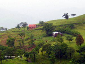 The two houses are widely separated on the hillside overlooking the monumental vista.