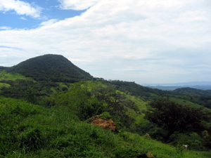 The varied terrain has high points such as this forested mountain.