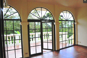 Arched French doors lead to the terrace and the swimming pool.