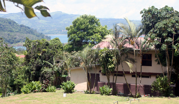 From other side of lake highway, the shot looks past the end of the hotel to the lake.