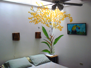 The Guanaaste room's mural displays a mural of a Guanaaste tree in bloom.