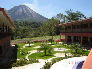 The landscaped gentle slope between the buildings contains curving walkways from the rooms to circular lounging spots.