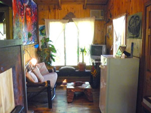 The living room in each cabin is small but pleasant and furnished with clever rustic furniture.