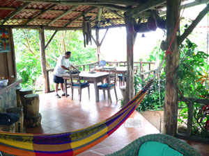 The dining area in the open-air covered rancho provides languid enjoyment of the surrounding greenery and distant views. 