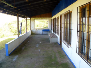 A covered porch fronts the three apartments, which each have bathrooms and kitchenettes. 