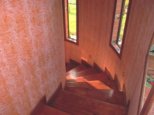 The handsome curving stairwell leads to the second-floor suites.