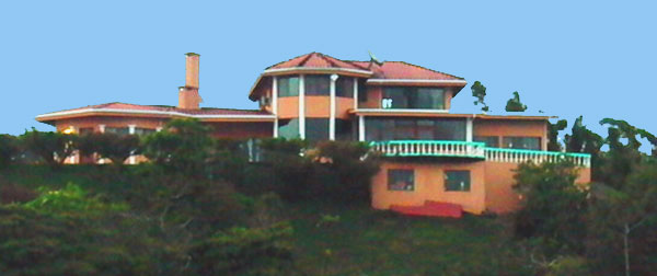 Red Sunset Inn crowns a hilltop high above Lake Arenal.