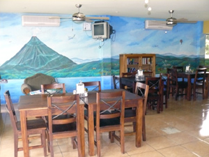 The restaurant interior has colorful murals of the region.