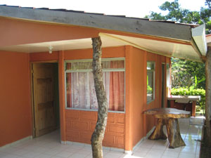 The front house has a covered patio on two sides and a carport.