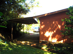 The drieway leads straight to the back house's carport, which is bordered by pretty landscaping.