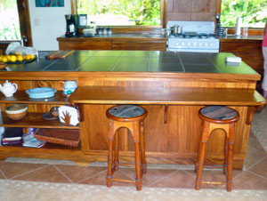 The kitchen has beautiful custom woodwork and much and much counter space. 