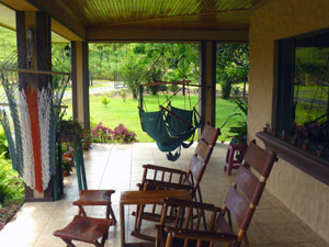 A wide veranda skirts most of two sides of the house.