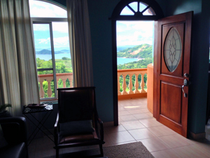 The lliving room and the deck outside have great views of the sunny bay.