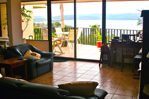 The open plan living room and kitchen as well as the deck have a great view of the cove, lake, and mountains. 