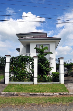 The home is behind a tall iron fence on a quoet lane that is a few blocks from the center of La Fortuna.