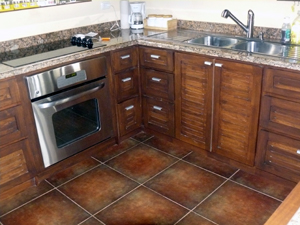 The bright kitchen has custom hardwood cabinetry and a fine vista. 