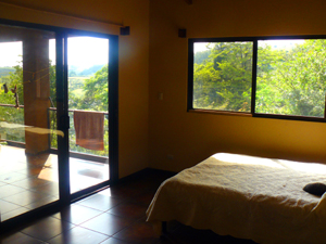 The master bedroom has an interior and a sliding glass exterior door. 