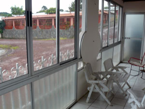 The glassed-in porch looks out on well-kept neighbors.