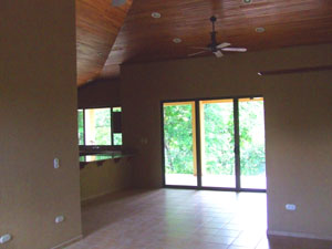 The open floor plan has a  cathedral ceiling of fine wood. 