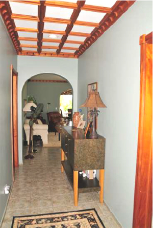 The hallway leads from the front entrance past the bedrooms and laundry room to the living room,