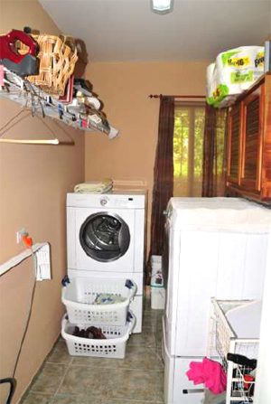 The laundry is in a fairly large separate room.