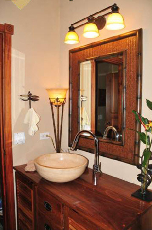 The master bathroom has, as do the other two bathrooms, unique bowls, hardware and cabinetry.