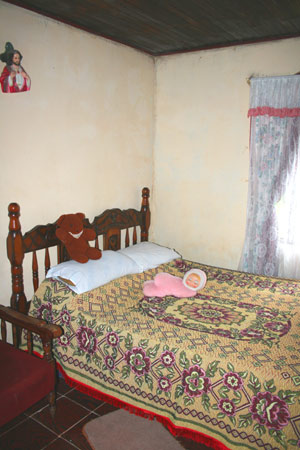 The bedrooms, like the rest of the house, have nice wooden ceilings. 