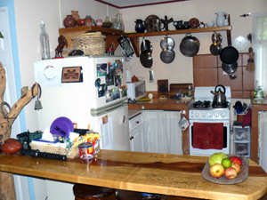 The kitchen is small but bright and nicely organized with a rustic breakfast bar.