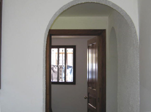 The Spanish colonial motif is carried out with arched doorways.