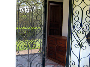 The entrance has attractive wrought iron security doors. 