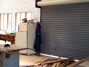 The bodega has a metal roll-up door.