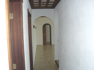 From the entrance a short hallway leads to a laundry room, the stairs to the tower, and the living room.