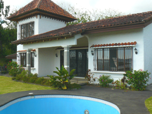 A swimming pool is located in the front garden and shares to wide vista.