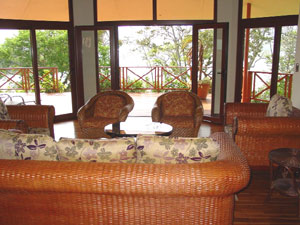 The living room has deck windows and doors on three sides.