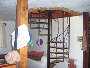 A spiral staircase leads to the second floor. 