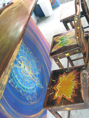 Colorful artistry decorates the table pedestal and the chairs. 