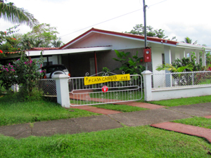 A paved driveway leads to a new double carport.