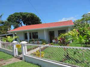 The reodeled home has a neat surrounding fence and very pleasing landscaping.