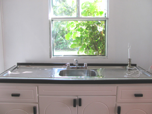 The kitchen has new though basic counter and sink.