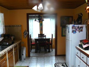 The separate dining room is at the end of the large kitchen.