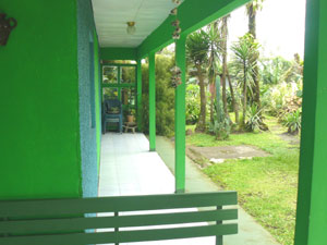 A long veranda runs along the east side of the house from the covered porch in front.