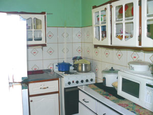 The tidy kitchen has unique wall cabinets. 